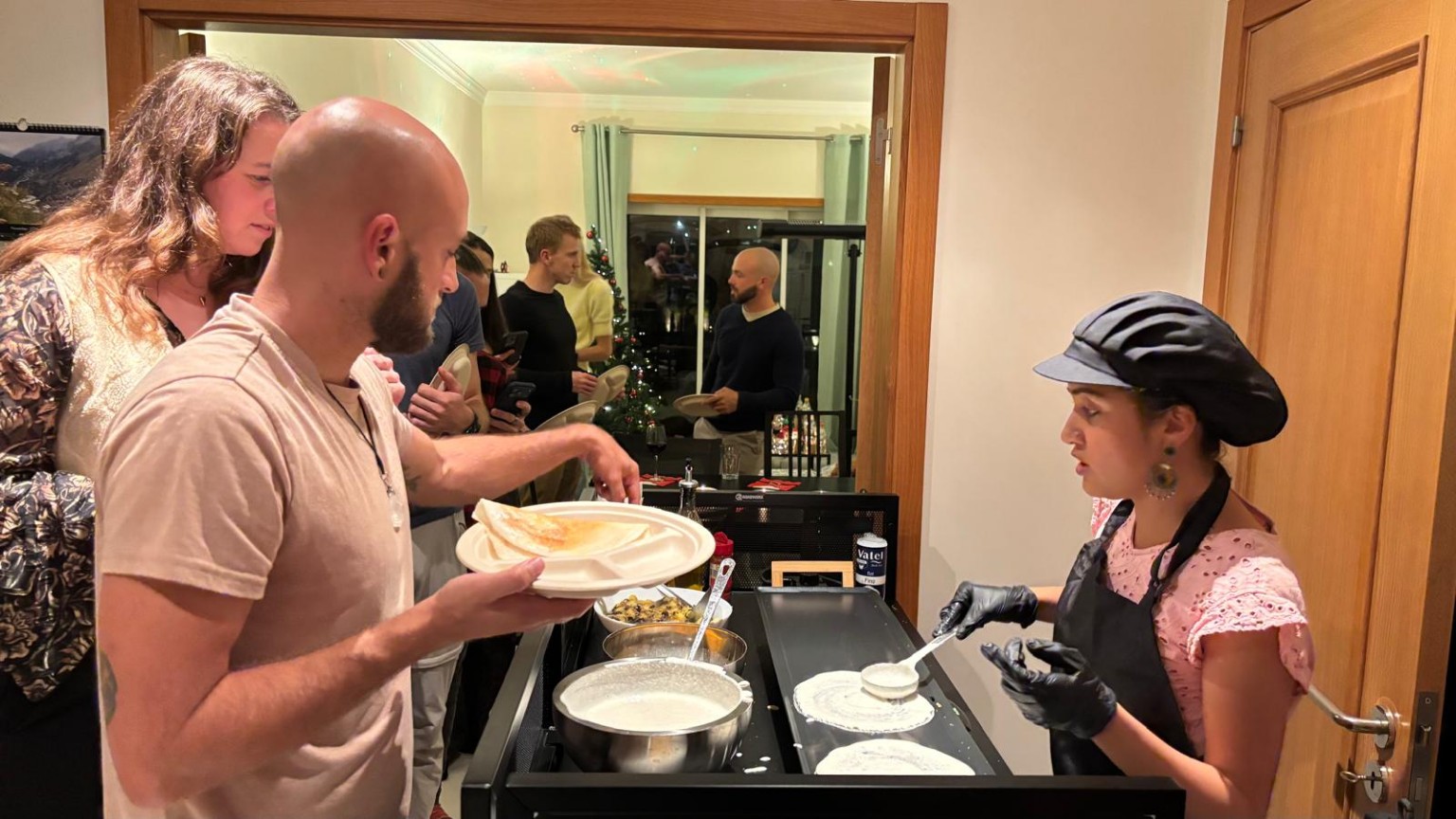 Guests choosing dosas while Anitha cooks at the live station